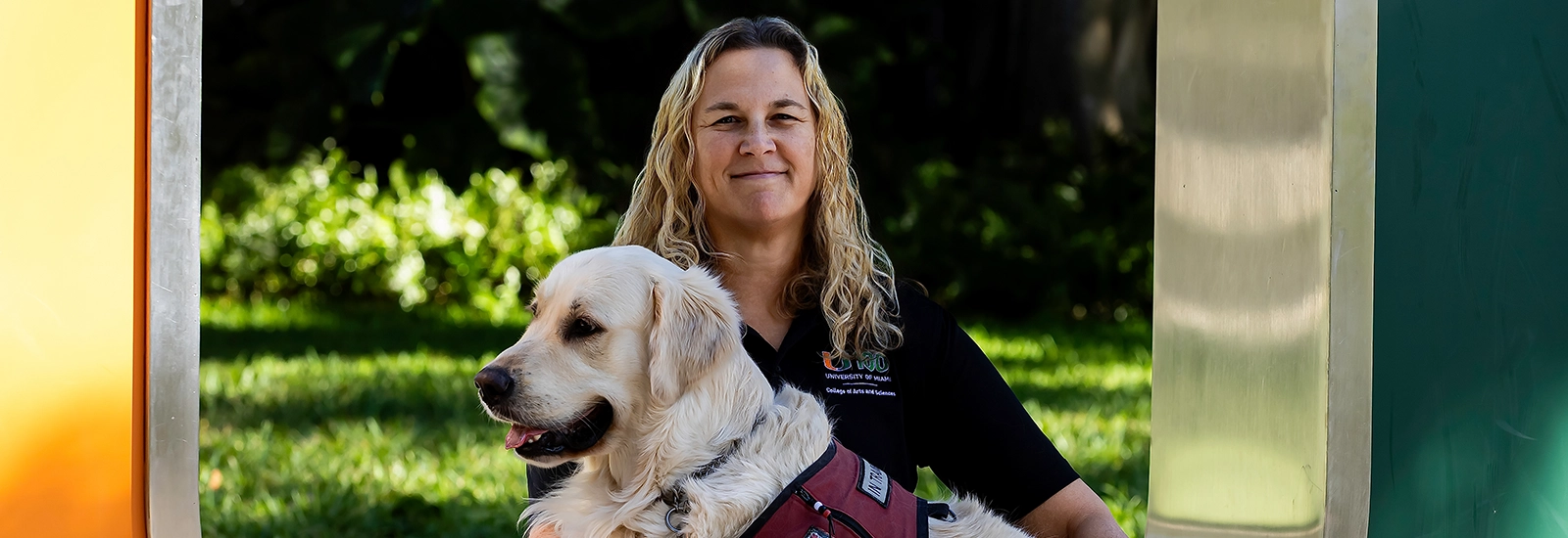 Nikki Frisbie with service dog in training August. Photo credit: Debora Cabrera/University of Miami